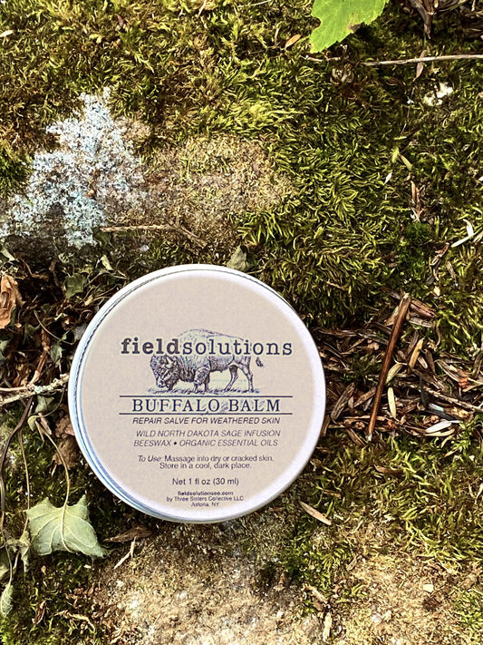 Buffalo Balm prairie sage salve tin resting on moss and lichen