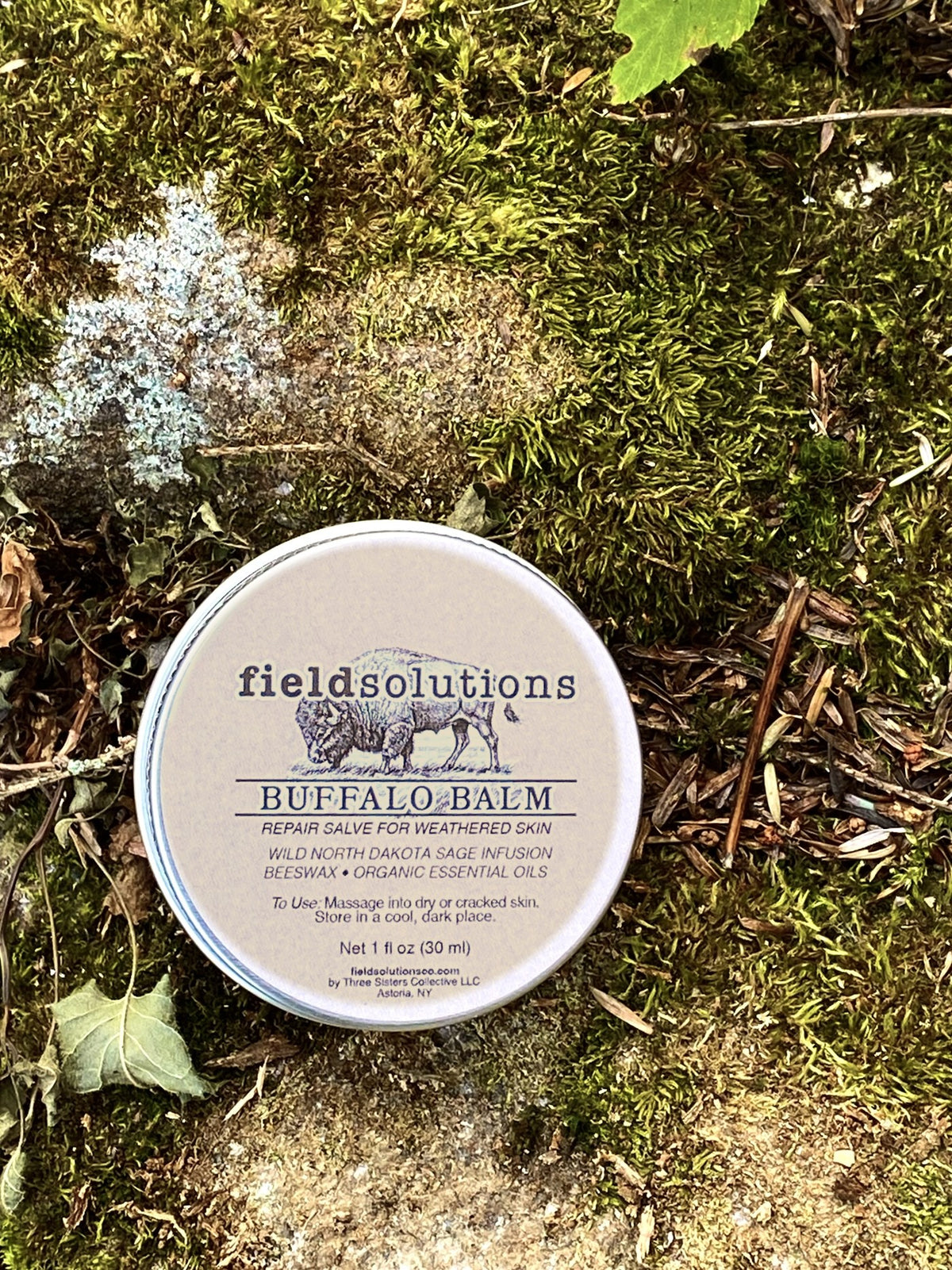 Buffalo Balm prairie sage salve tin resting on moss and lichen