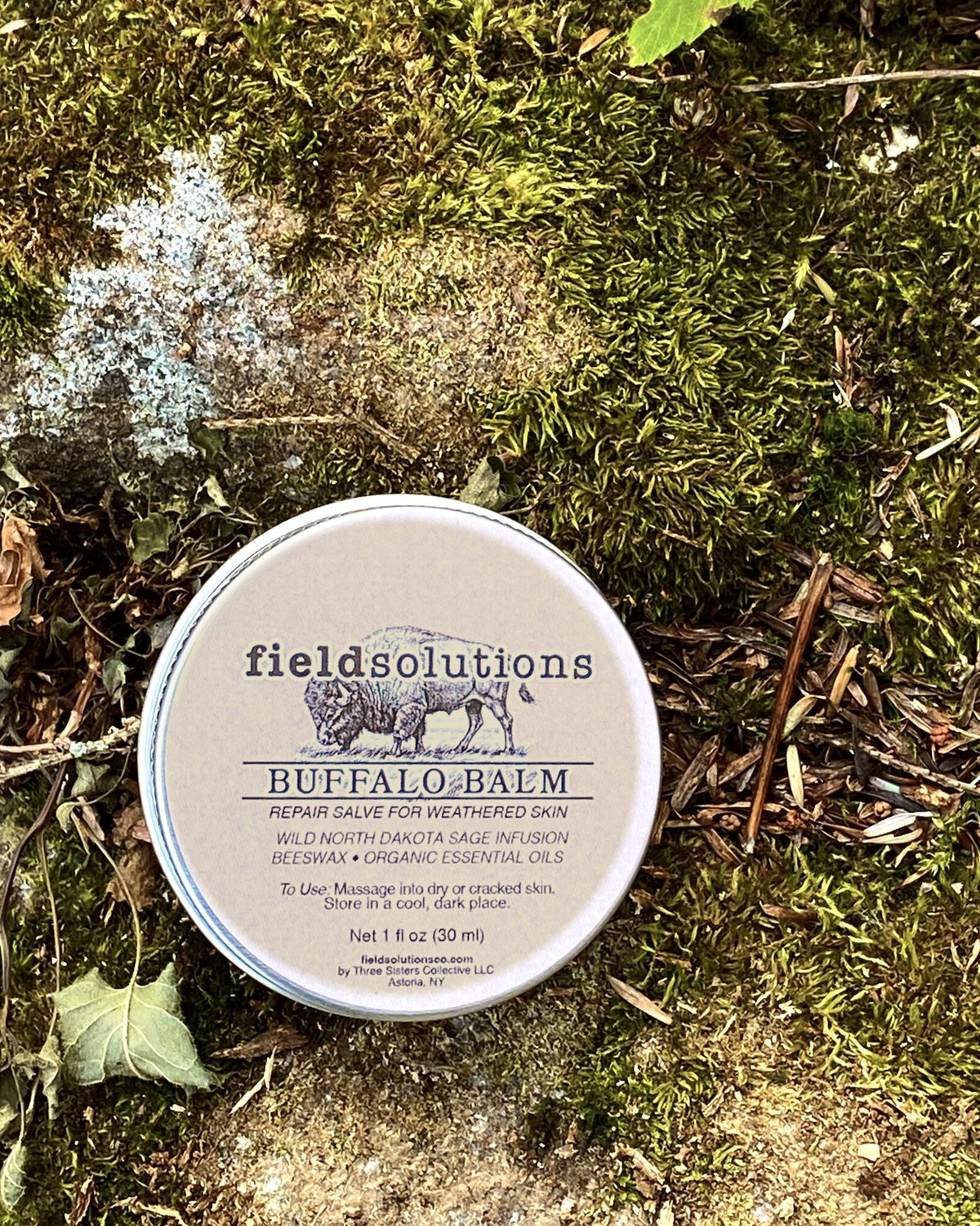 Buffalo Balm wild prairie sage salve tin resting on moss and lichen